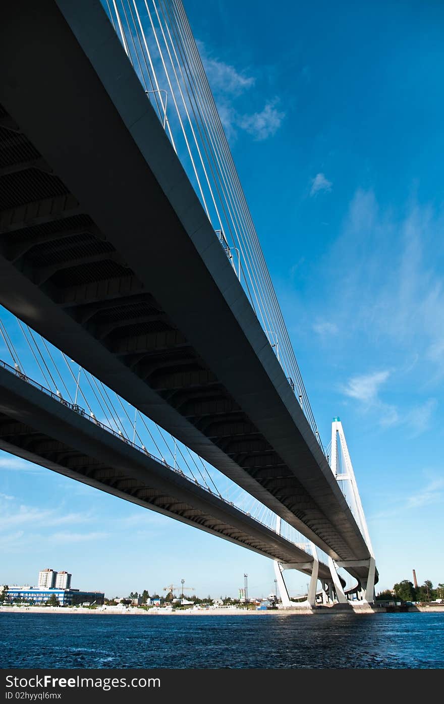 Cable-braced bridge across the river Neva, Russia, St. Petersburg. Blue sky with clouds. Obukhovsky.