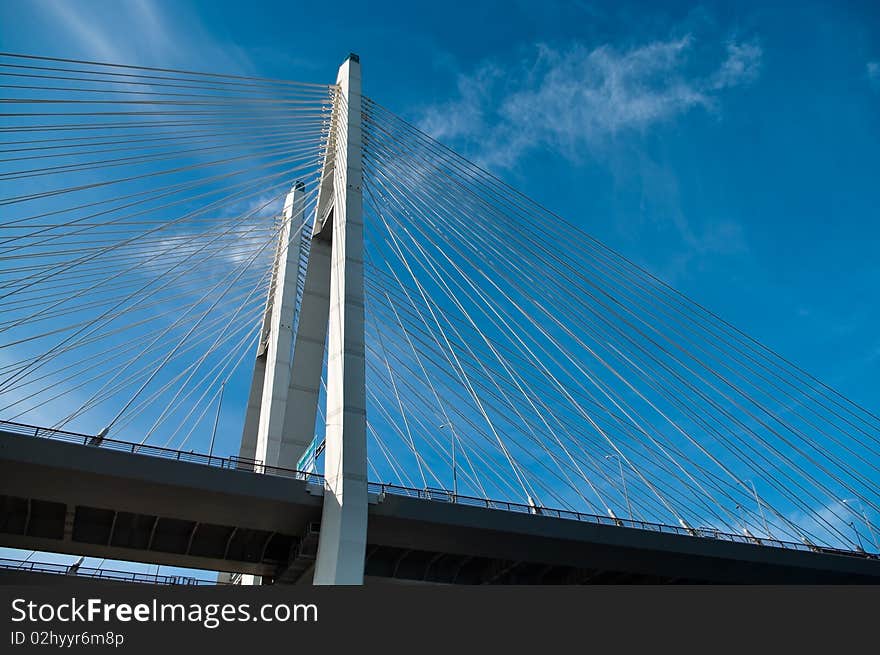 Cable-braced bridge across the river Neva, Russia, St. Petersburg. Blue sky with clouds. Obukhovsky.