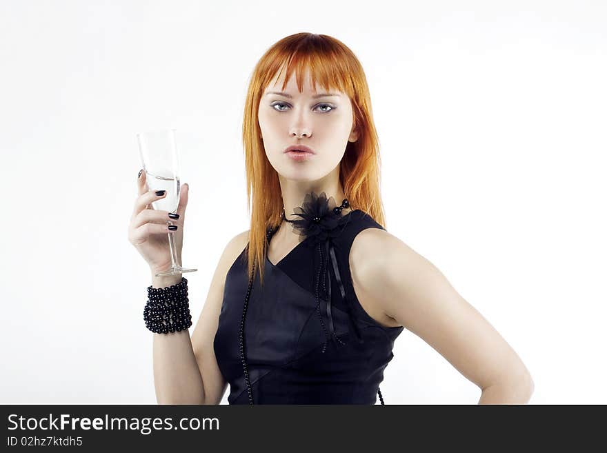 Beautiful red-haired girl lifts a toast, a glass with champagne