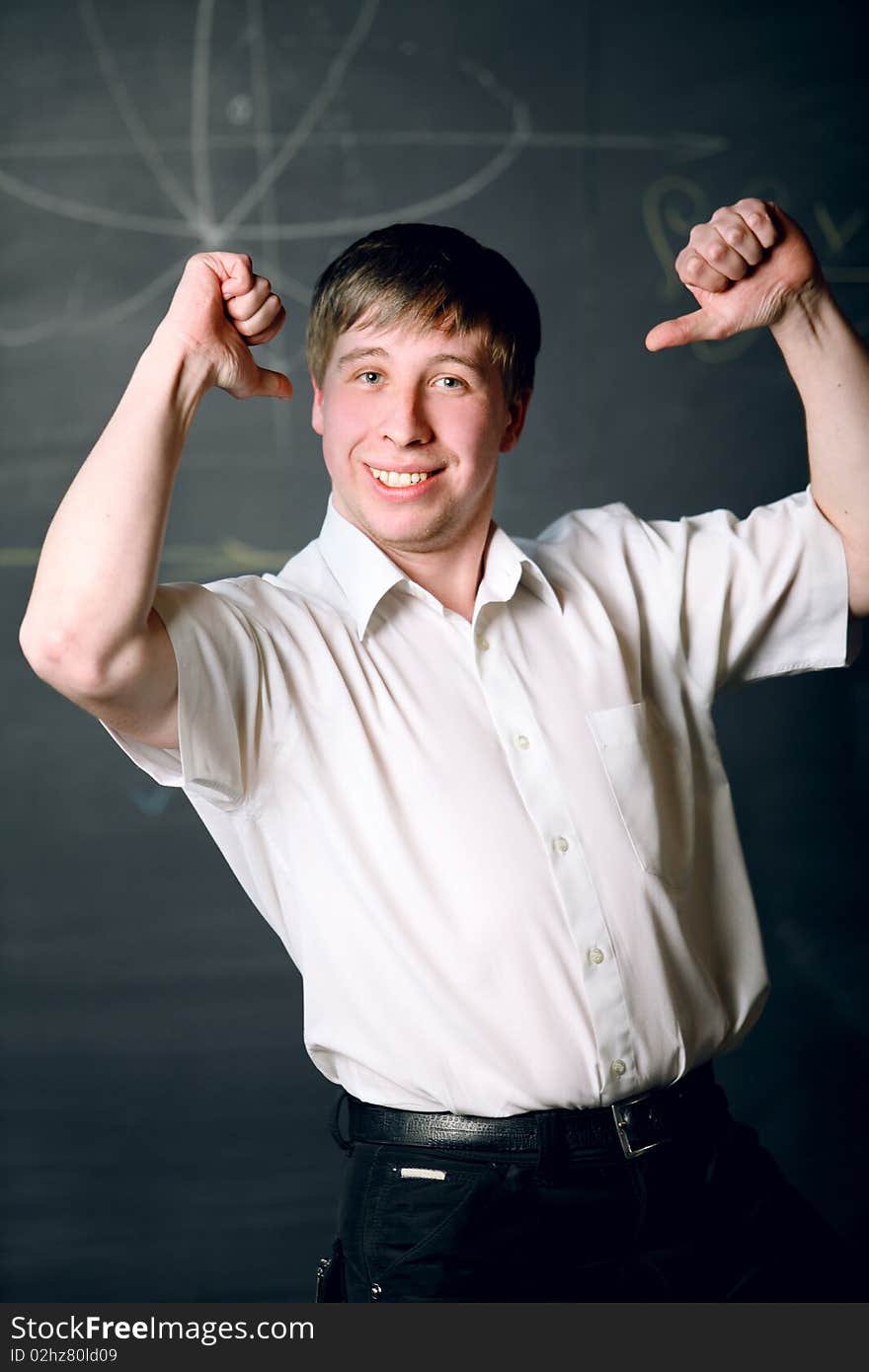 I super! young man in a white shirt is glad to the success. I super! young man in a white shirt is glad to the success