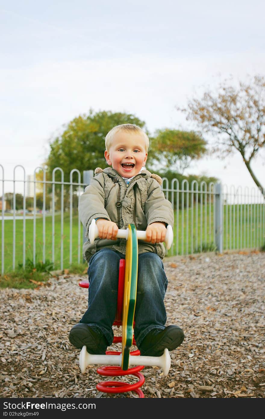 Three year old boy playing in park. Three year old boy playing in park