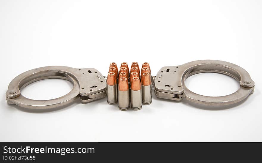 Pair of police handcuffs and 14 9 mm bullets. Pair of police handcuffs and 14 9 mm bullets