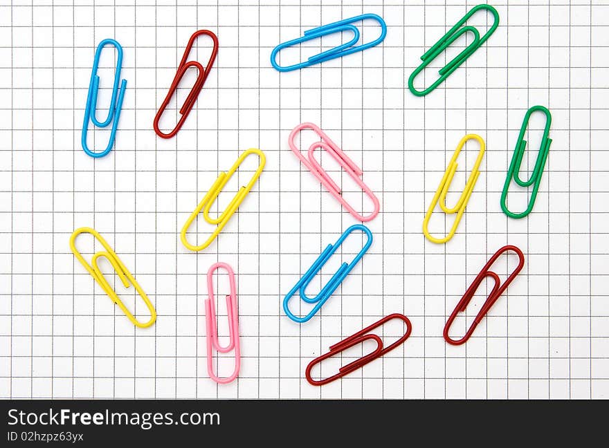 The image of paper clips on notepad page background