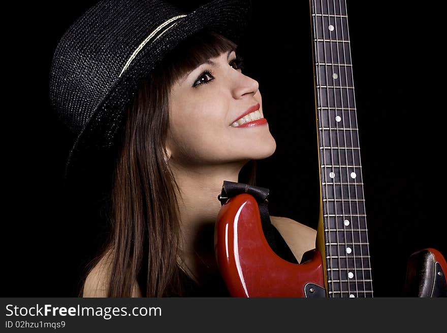 Female country singer holding a red guitar