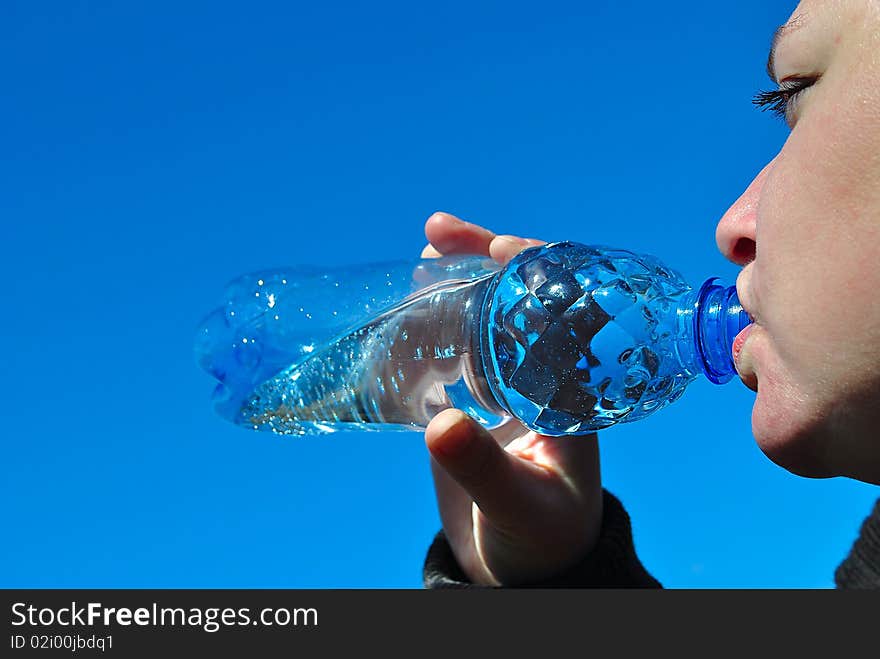 Water. Girl drinks from the bottle.