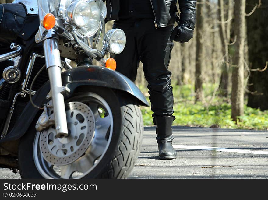 Biker stands near his bike