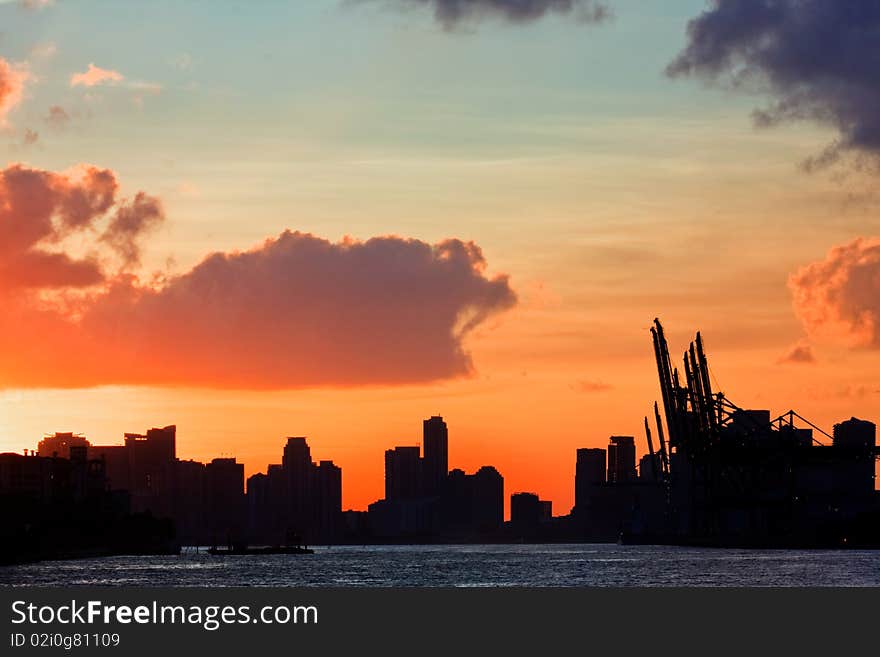 Beautiful colorful sunset over the port of Miami Florida with downtown buildings seen in the distance