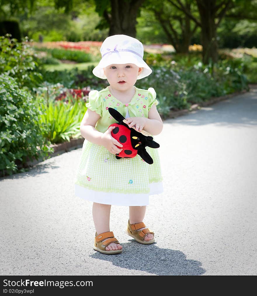 Portrait of the baby girl in the garden