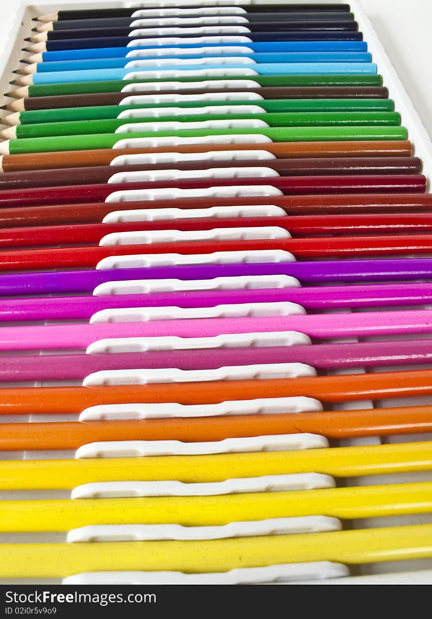 A line of colored pencils in various colors. A line of colored pencils in various colors