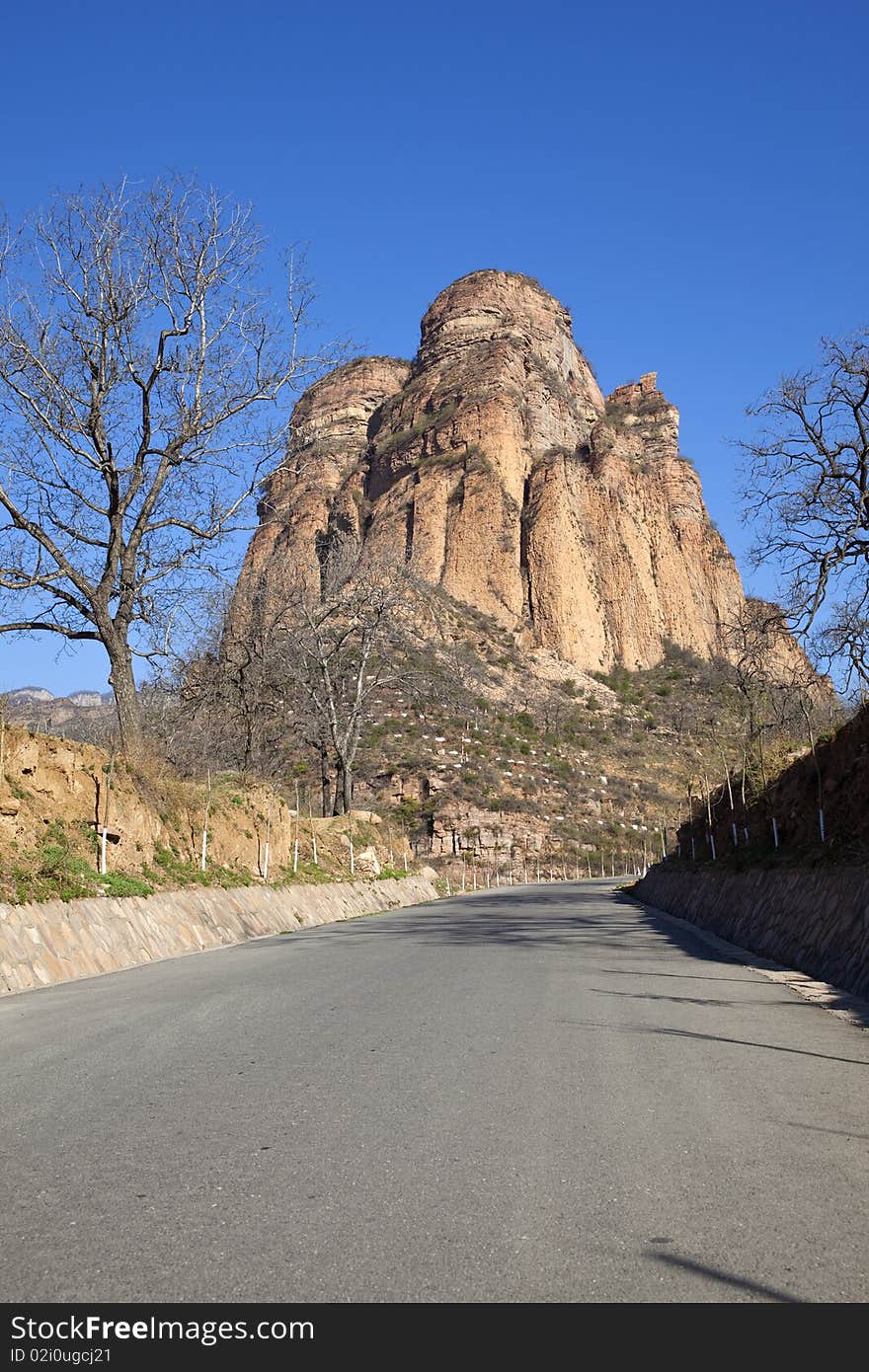 The asphalt road towards the rocky mountain in China. The asphalt road towards the rocky mountain in China