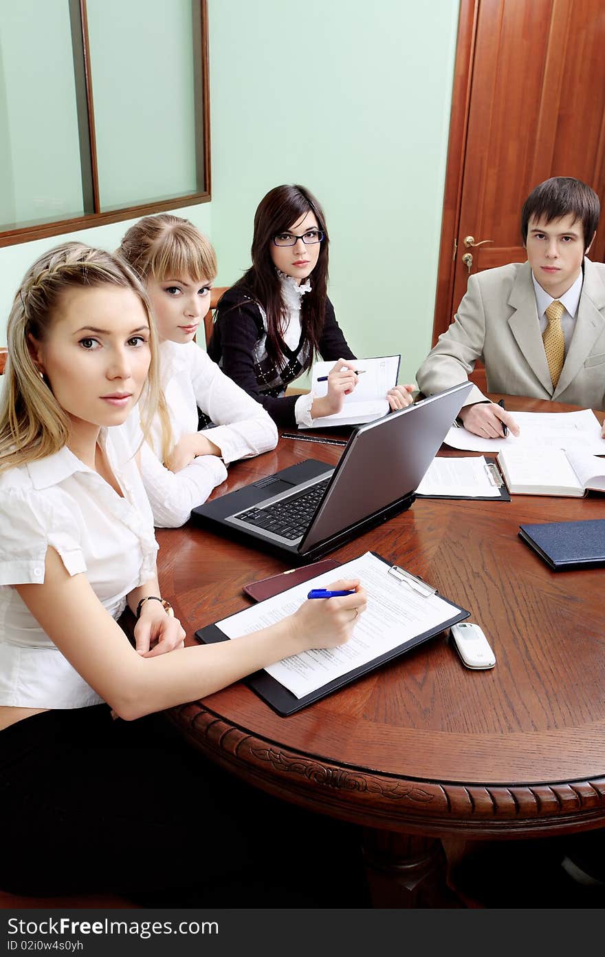 Group of business people interacting together at the office. Group of business people interacting together at the office.