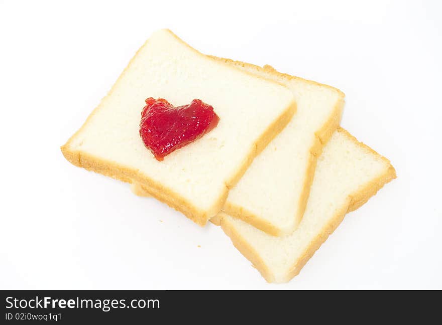 Bread with strawberry jam on white background