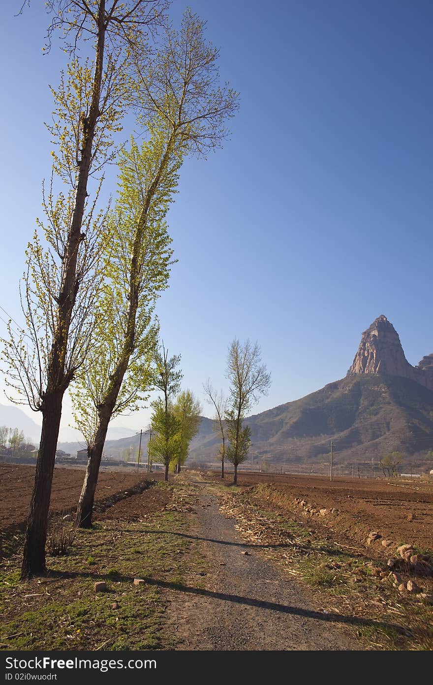 The uncultivated fields at the foot of the rocky mountains in China. The uncultivated fields at the foot of the rocky mountains in China