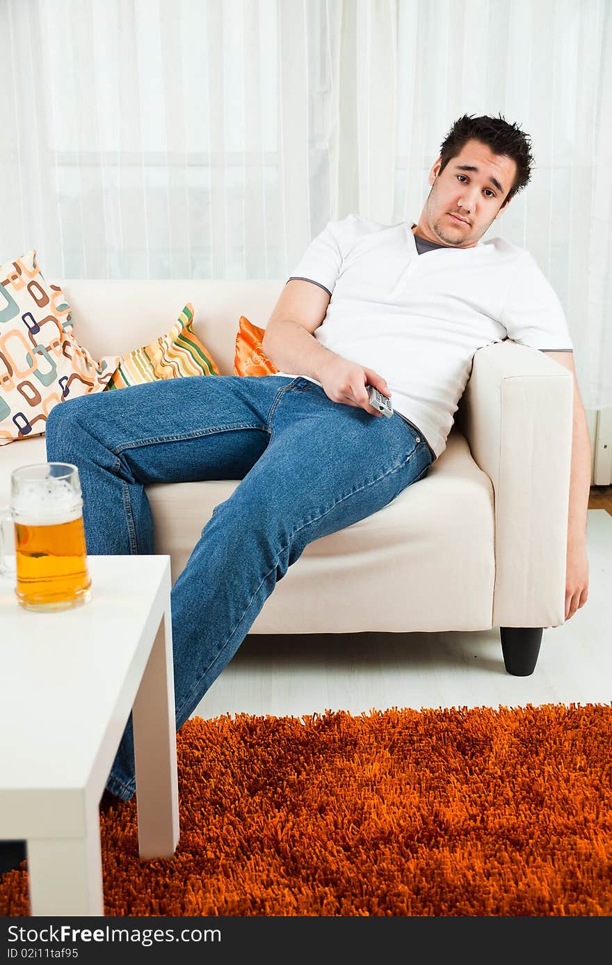 Handsome young boy watching television at home