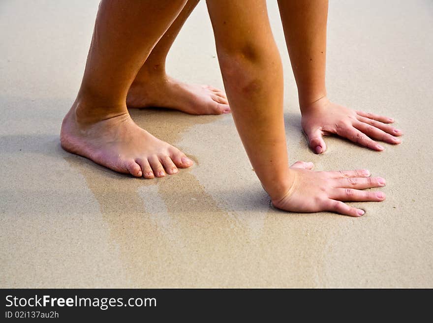 Feet on the beautiful sandy beach. Feet on the beautiful sandy beach