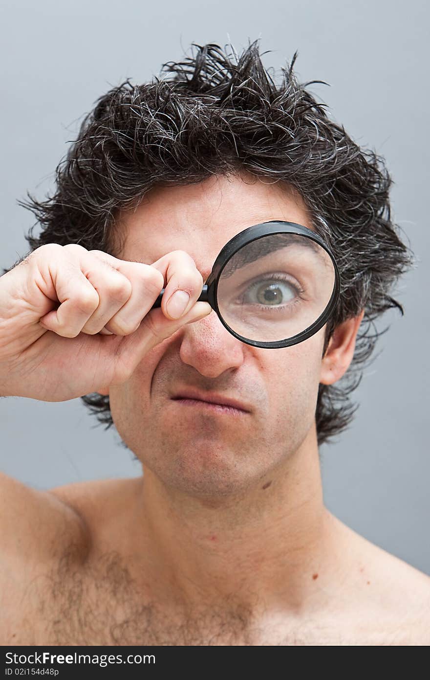 Curious man examining with magnifying glass. Curious man examining with magnifying glass