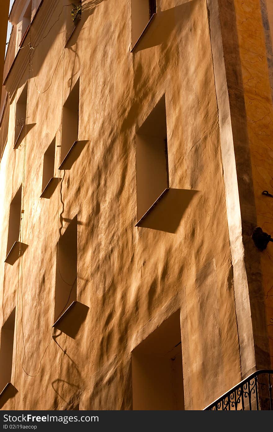 The front of a house in Barcelona brightly colored in the evening sunlight. The front of a house in Barcelona brightly colored in the evening sunlight