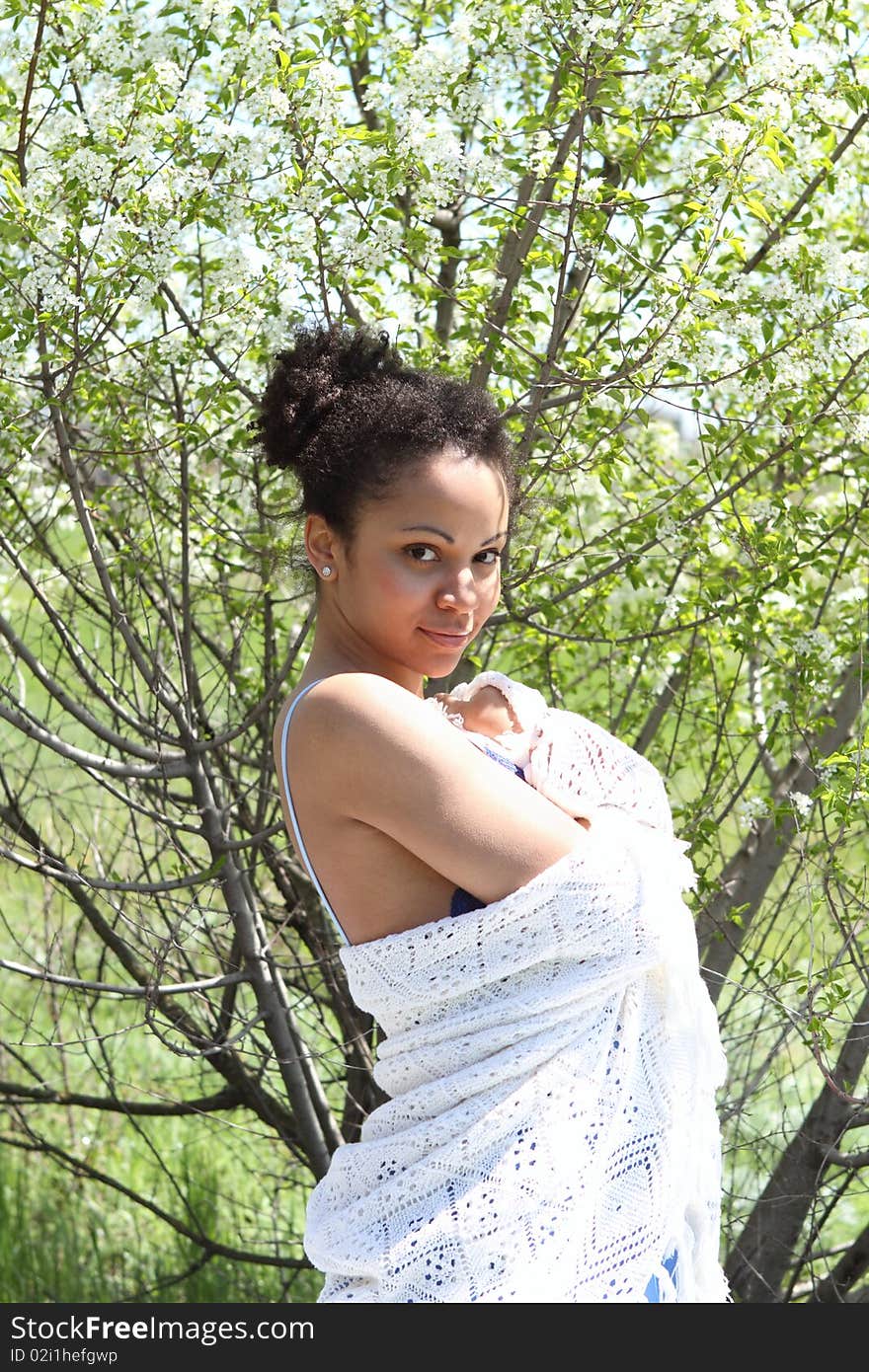 A beautiful mixed race African American girl with a white shawl