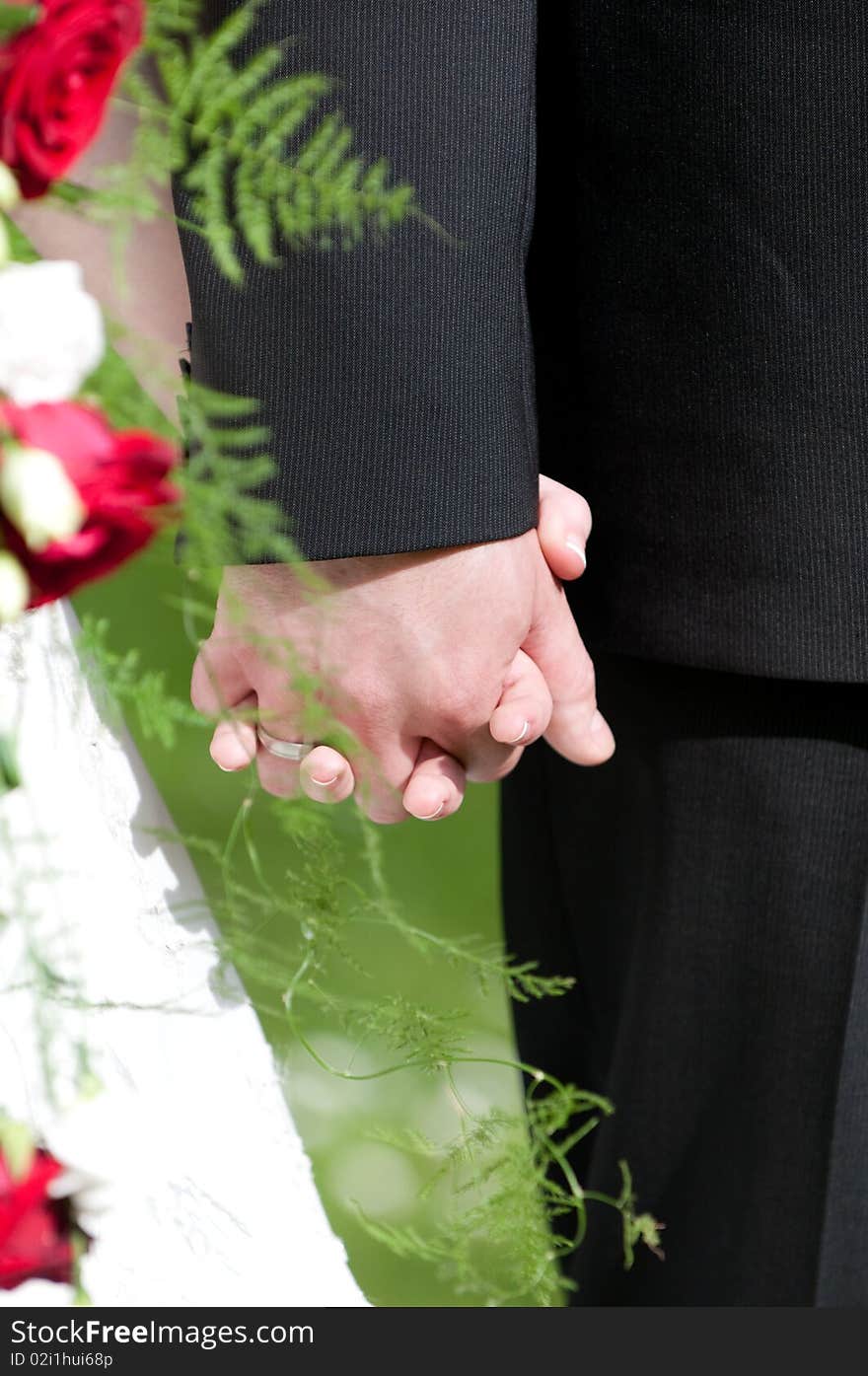 Bride holds Brautrauss with roses in hand. Bride holds Brautrauss with roses in hand