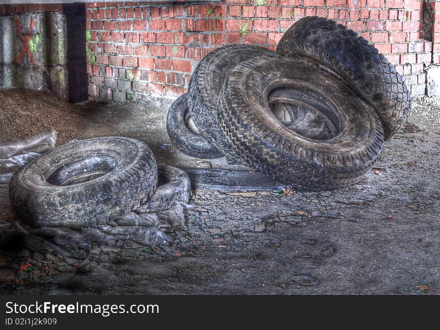 A pack of old tires and lot of rubbish around