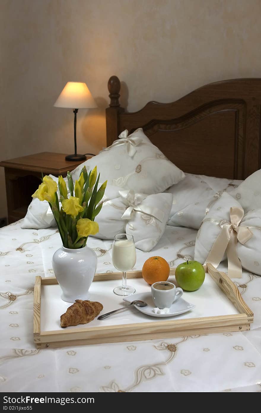 Tray with breakfast on a bed in a hotel room