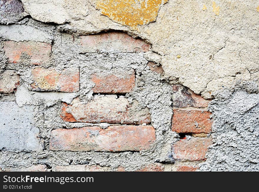 Fragment of tumbledown plastered brick wall. Fragment of tumbledown plastered brick wall