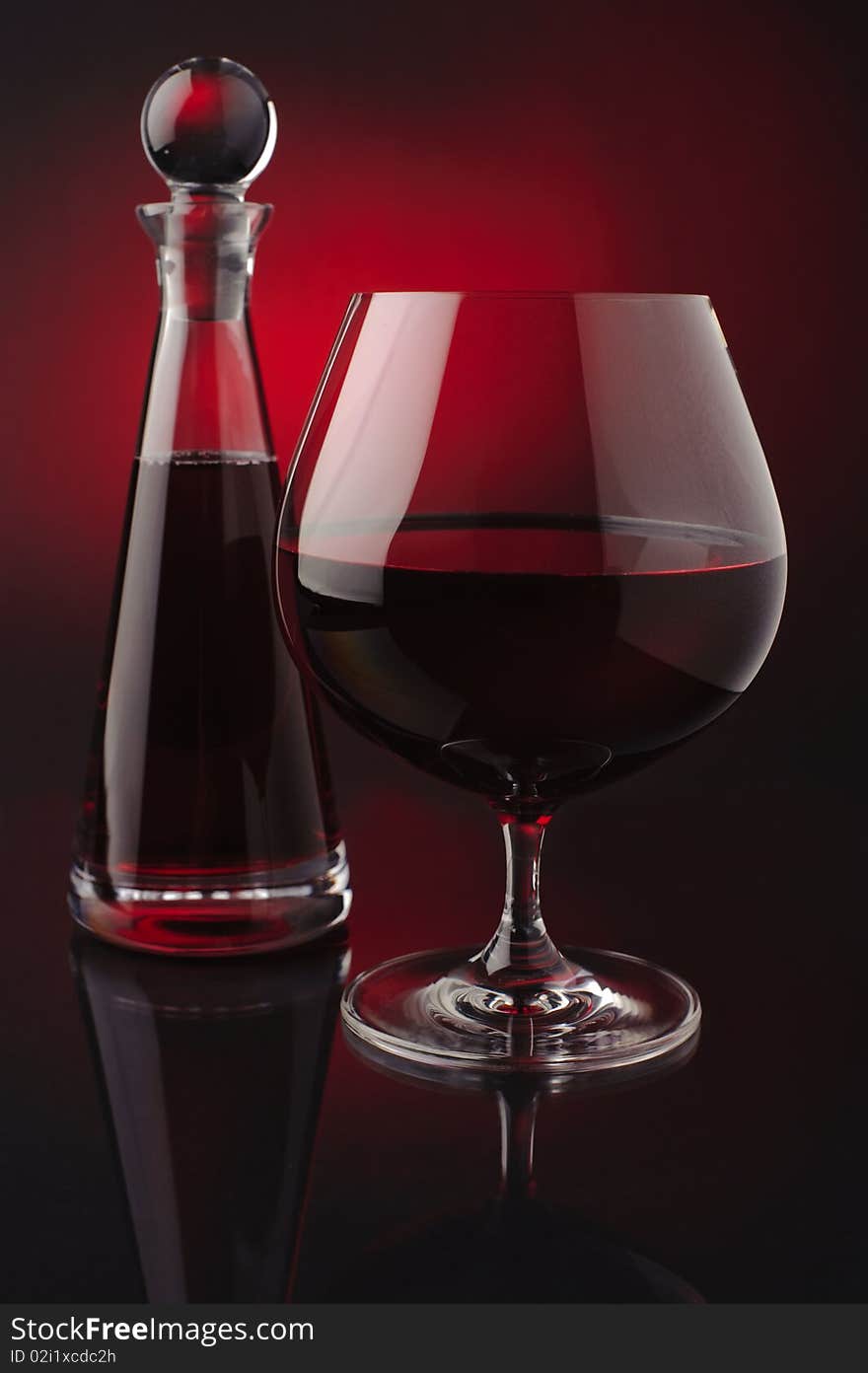 Red wine with carafe on red and black background