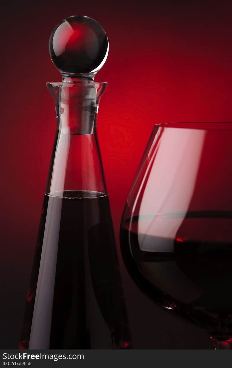 Red wine with carafe on red and black background