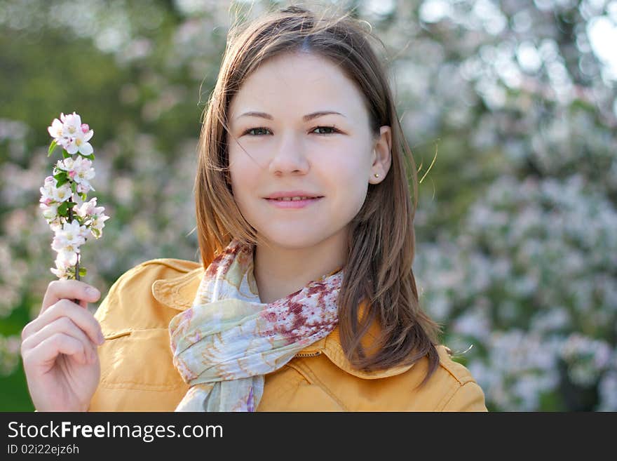 Young woman in blooming park