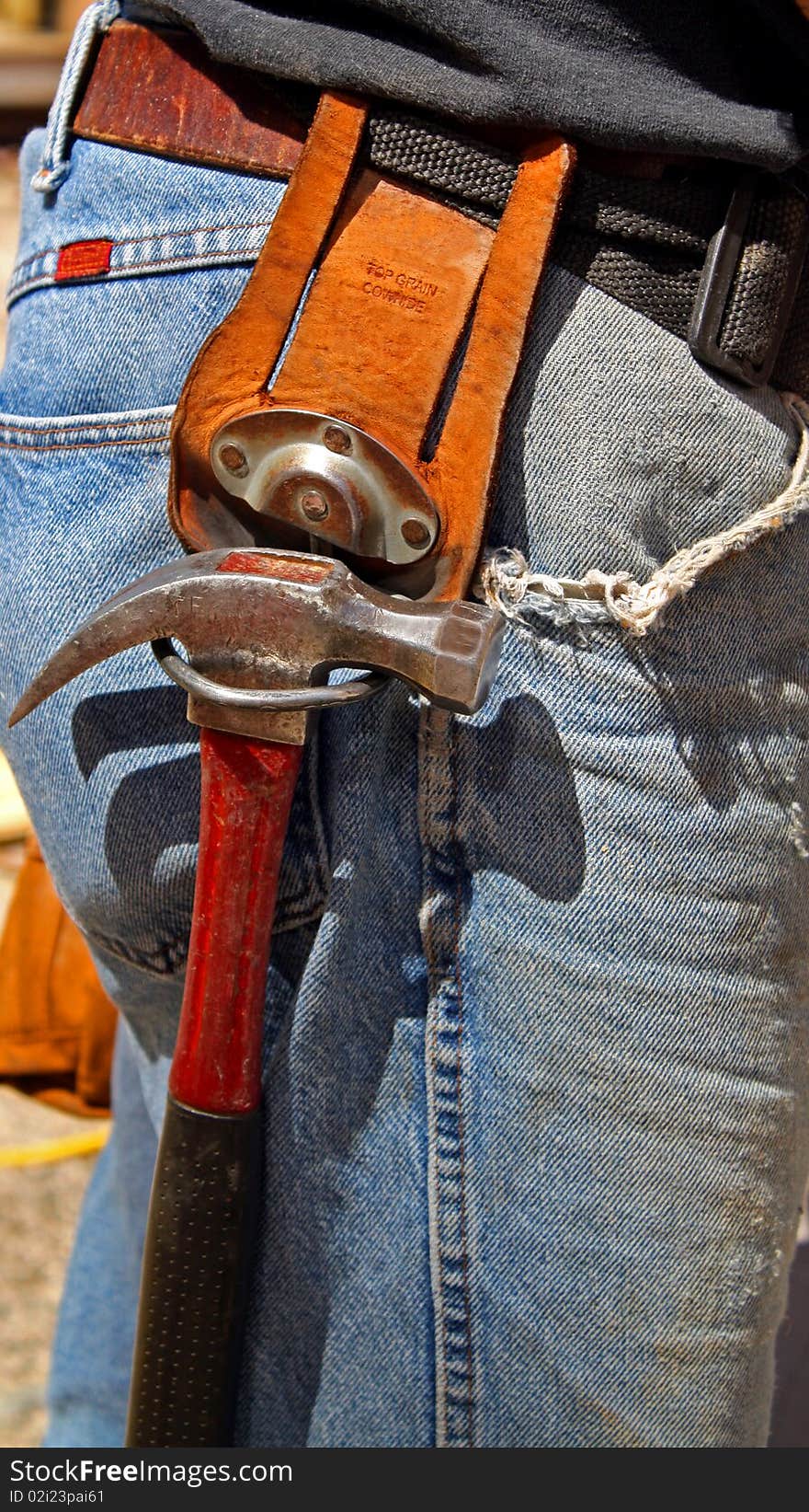 Old hammer hanging from belt hammer holder. Old hammer hanging from belt hammer holder