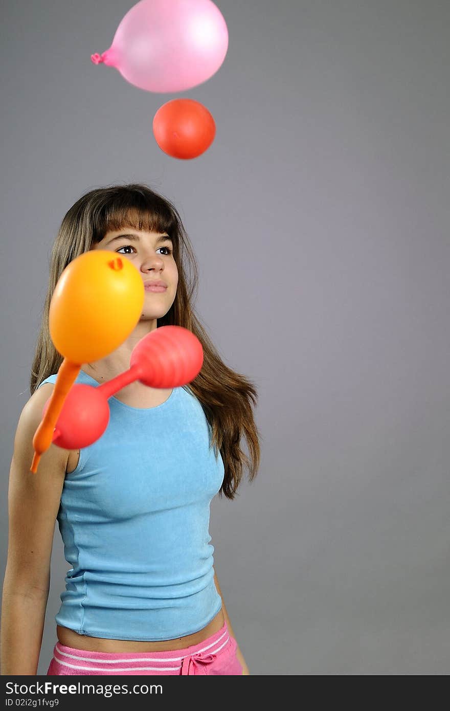 Beautiful child partying with colored objects in studio. Beautiful child partying with colored objects in studio