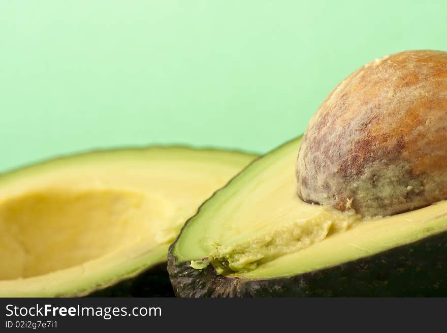 Close up of an avocado on a green background