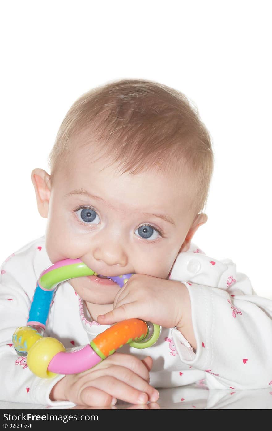 Portrait of the newborn child with a toy in a hand. Portrait of the newborn child with a toy in a hand