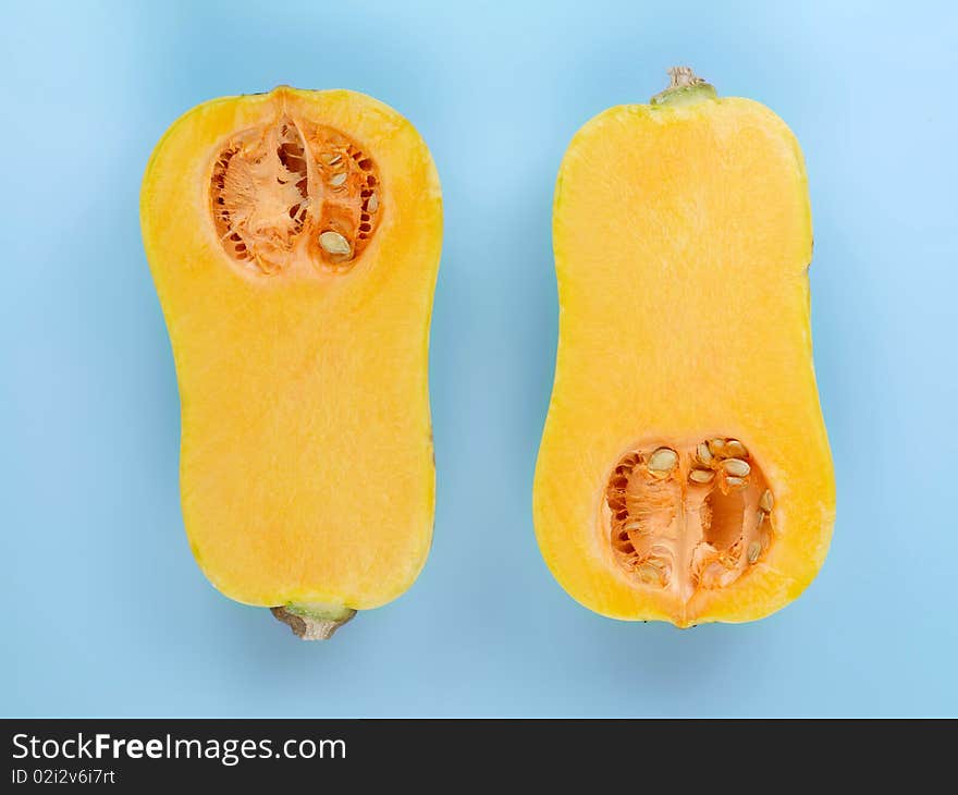 Butternut pumpkin isolated against a blue background