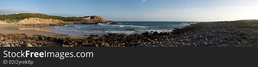 A panorama of a beach in the Algarvian west coast in a sunny afternoon. A panorama of a beach in the Algarvian west coast in a sunny afternoon.