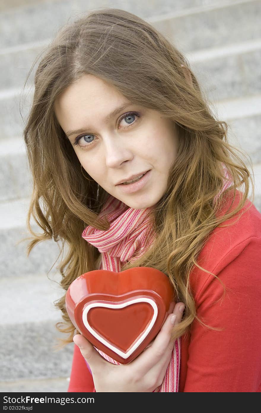 A beautiful young woman holding a red heart. Valentine. A beautiful young woman holding a red heart. Valentine