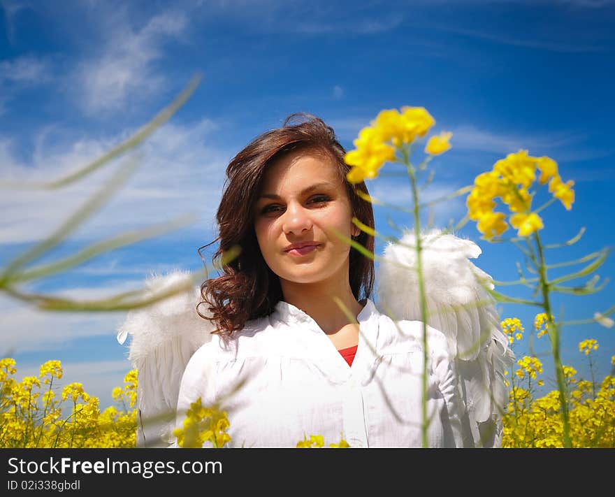 Happy girl with angel wings looking