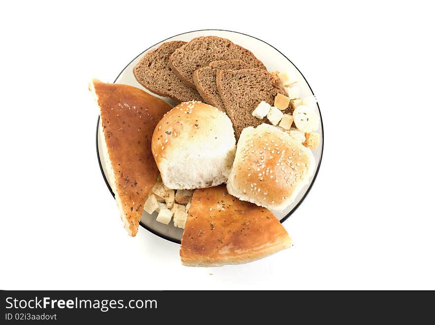 White bread,pita, crackers,rye bread in a plate on a white background. White bread,pita, crackers,rye bread in a plate on a white background