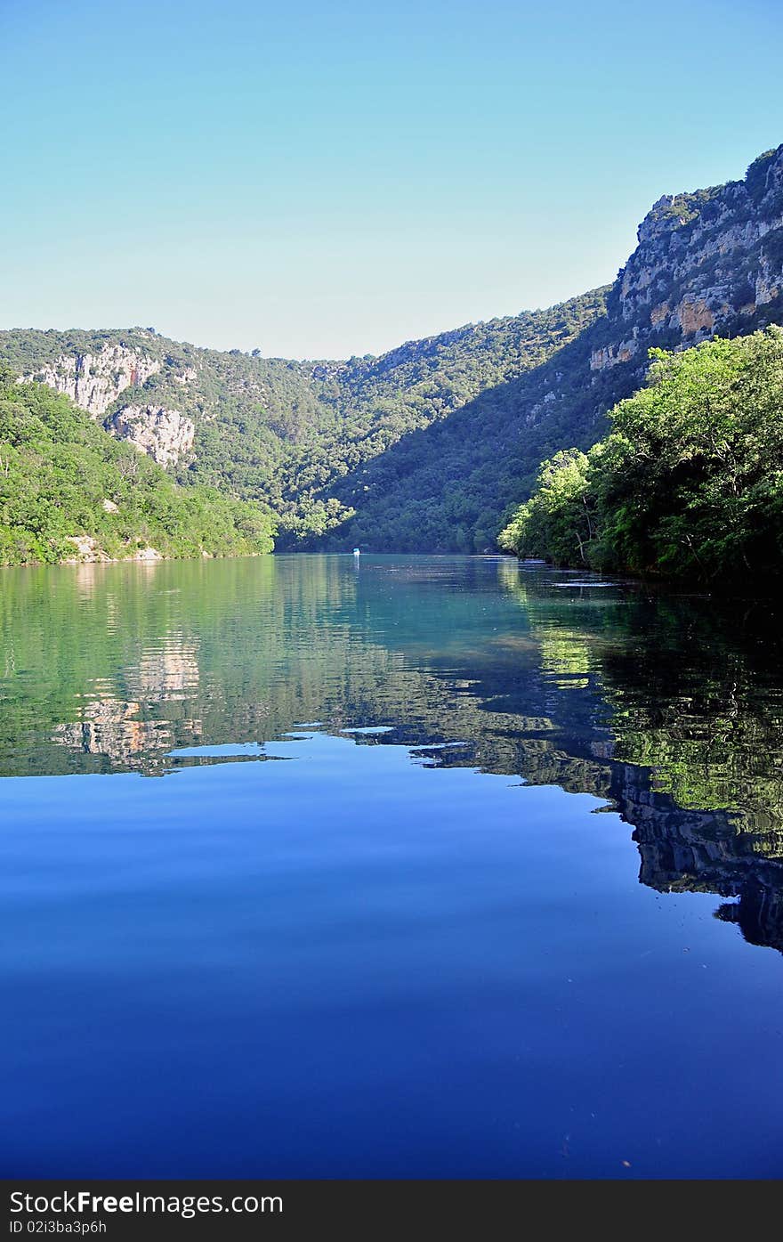 Photo taken on the Verdon River with reflections of the Hill in the water