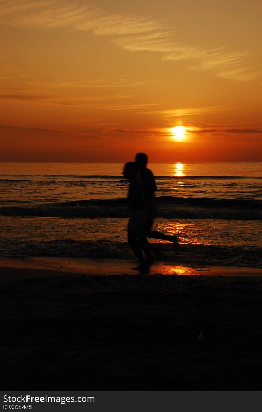 Two guys jogging on the beach in mamaia romania at sunrise. Two guys jogging on the beach in mamaia romania at sunrise