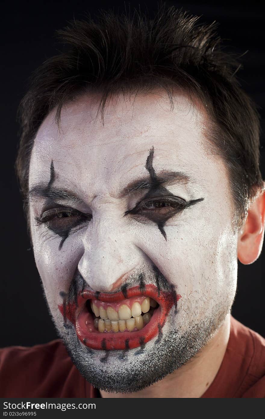 Clown looking at camera on a black background. Clown looking at camera on a black background