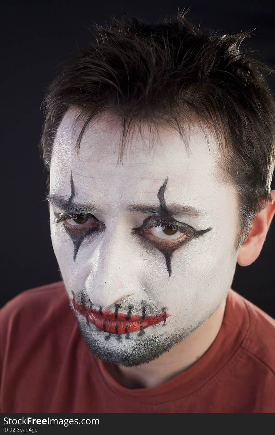 Clown looking at camera on a black background. Clown looking at camera on a black background