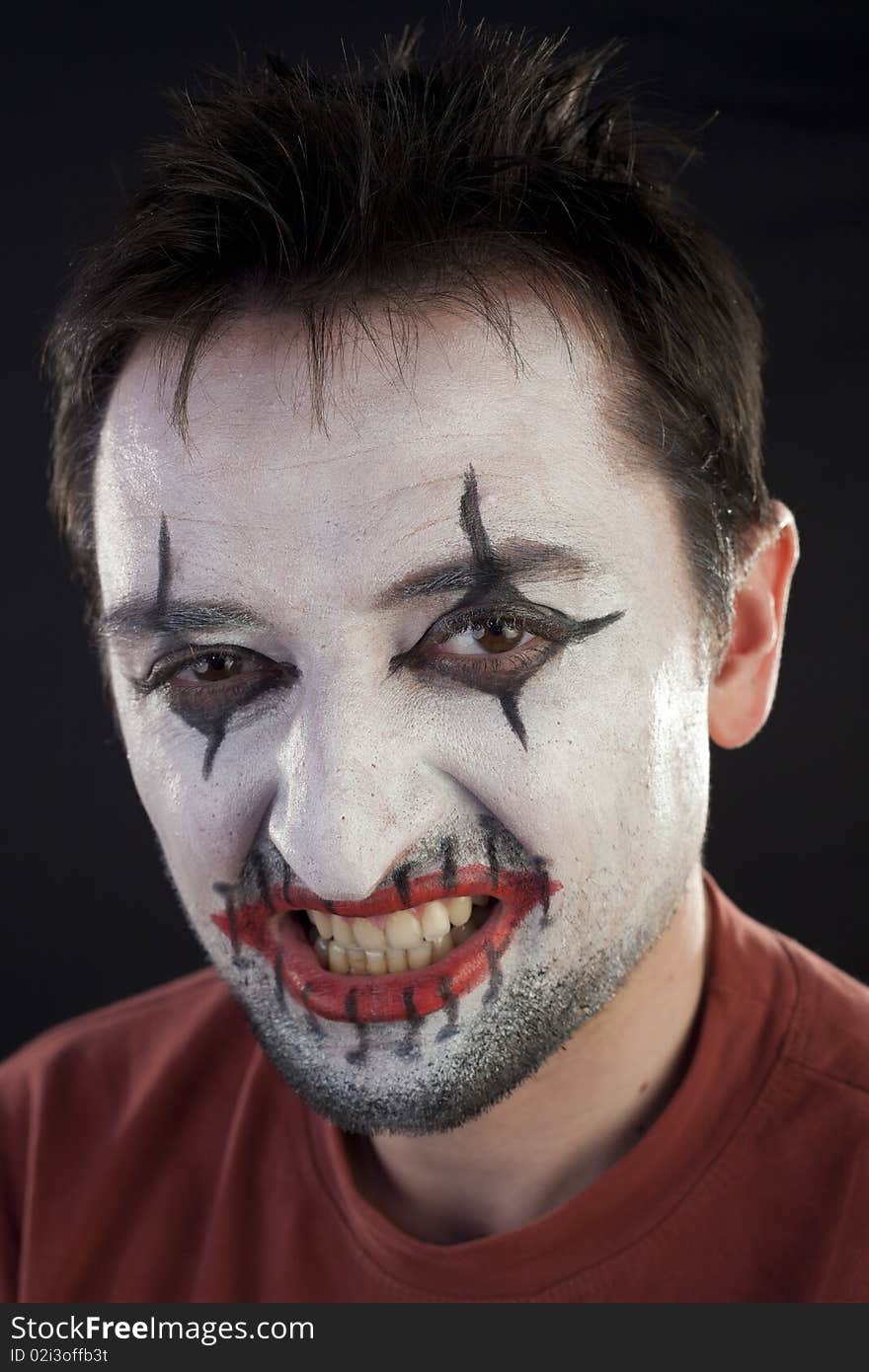 Clown looking at camera on a black background. Clown looking at camera on a black background