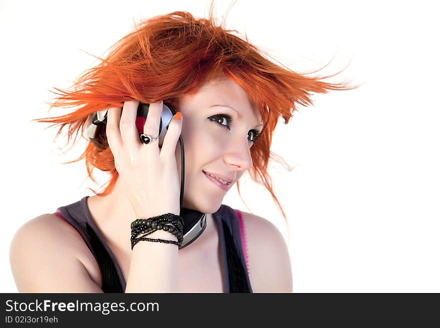 Redhead young woman holding headphones and dancing. Redhead young woman holding headphones and dancing