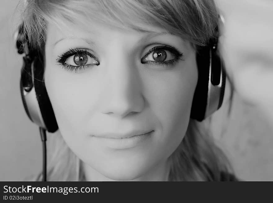 Young woman with headphones posing on a vintage background. Young woman with headphones posing on a vintage background