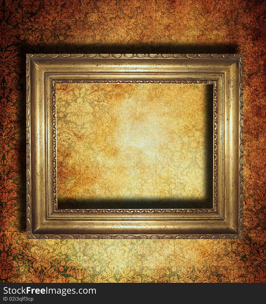 Vintage golden frame over a grunge wallpaper