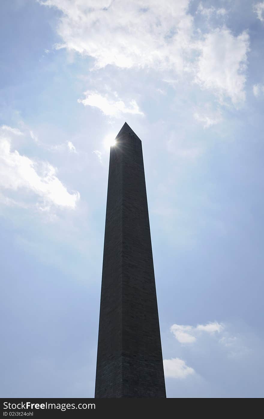 Washington monument in Washington DC against blue sky with flare