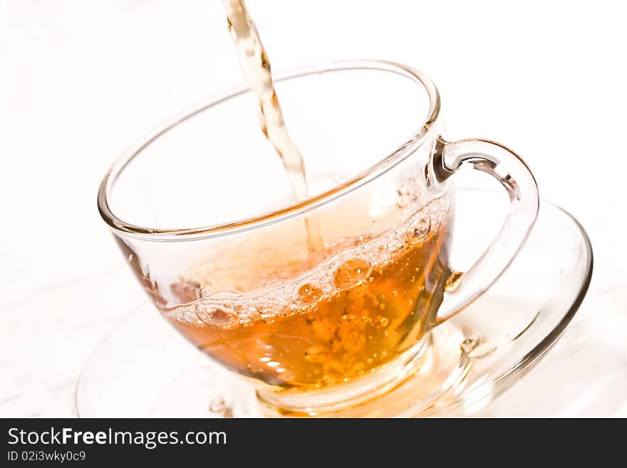 Drink series: pouring tea into glassy tea cup