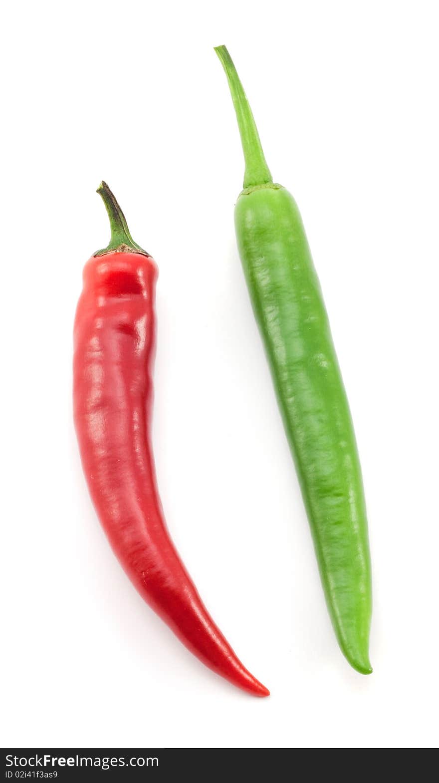 Green and red chili peppers on white background