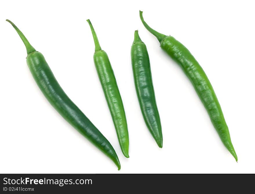 Green chili peppers on white background